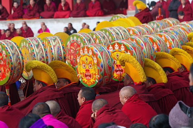 (260302) -- XIAHE, March 2, 2026 (Xinhua) -- Lamas play traditional musical instruments during an exorcism dance performance in a square at the Labrang Monastery in Xiahe County, northwest China's Gansu Province, on March 2, 2026. The annual event of exorcism dance to pray for good luck in the new year was held here on Monday. Built in 1709, Labrang Monastery is one of the six great monasteries of the Gelug Sect of Tibetan Buddhism. (Xinhua/Liu Keying)