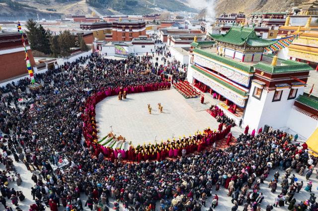 (260302) -- XIAHE, March 2, 2026 (Xinhua) -- An aerial drone photo taken on March 2, 2026 shows an event of exorcism dance at the Labrang Monastery in Xiahe County, northwest China's Gansu Province. The annual event of exorcism dance to pray for good luck in the new year was held here on Monday. Built in 1709, Labrang Monastery is one of the six great monasteries of the Gelug Sect of Tibetan Buddhism. (Xinhua/Liu Keying)