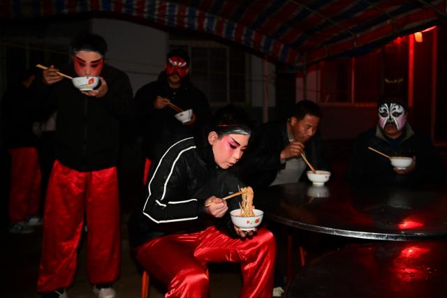 (260302) -- BAOJI, March 2, 2026 (Xinhua) -- Members of a Shehuo parade team have breakfast in Huanghuayu Village in Longxian County of Baoji City, northwest China's Shaanxi Province, in the early morning of March 2, 2026.
  Shehuo is a type of traditional Chinese folk art form. Longxian County held a special local Shehuo parade on Monday, which features performers on horseback adorned with simple yet exquisite facial make-up.
  The Shehuo parade is a long-standing and widely popular performance in rural China. It originated in ancient sacrificial ceremonies held to pray for good harvests about 2,000 years ago.
  Over time, as dance and song performances were incorporated, it gradually evolved into a folk custom staged during the Spring Festival and Lantern Festival, believed to ward off bad luck and usher in a fresh start for the new year.
  The Shehuo folk performance in Baoji was added to China's national intangible cultural heritage list in 2006. In recent years, the local Shehuo tradition in Longxian County has continued to thrive through ongoing inheritance and innovation. (Xinhua/Zou Jingyi)