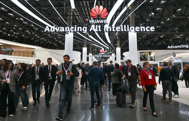 (260302) -- BARCELONA, March 2, 2026 (Xinhua) -- People visit the booth of Huawei during the 2026 Mobile World Congress (MWC) in Barcelona, Spain, March 2, 2026. The 2026 MWC opened on Monday in Barcelona, Spain, under the theme "The IQ Era," with a focus on intelligent infrastructure, AI connectivity and integration, enterprise-level AI applications, AI ecosystem collaboration, inclusive technology and innovation-driven transformation. (Xinhua/Cheng Min)