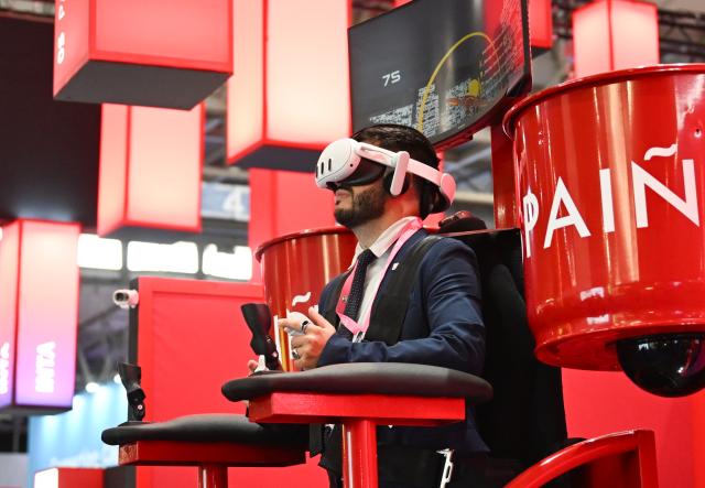 (260302) -- BARCELONA, March 2, 2026 (Xinhua) -- A visitor is seen during the 2026 Mobile World Congress (MWC) in Barcelona, Spain, March 2, 2026. The 2026 MWC opened on Monday in Barcelona, Spain, under the theme "The IQ Era," with a focus on intelligent infrastructure, AI connectivity and integration, enterprise-level AI applications, AI ecosystem collaboration, inclusive technology and innovation-driven transformation. (Xinhua/Cheng Min)