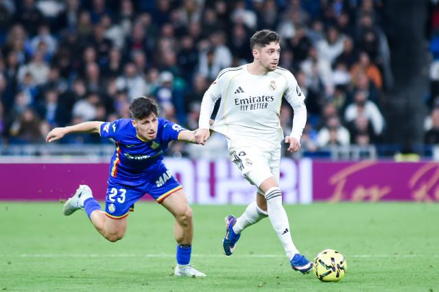 (260303) -- MADRID, March 3, 2026 (Xinhua) -- Real Madrid's Federico Valverde (R) vies with Getafe's Adrian Liso during the La Liga football match between Real Madrid and Getafe CF in Madrid, Spain, on March 2, 2026. (Photo by Gustavo Valiente/Xinhua)