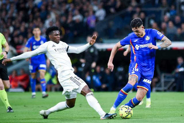 (260303) -- MADRID, March 3, 2026 (Xinhua) -- Real Madrid's Aurelien Tchouameni (L) vies with Getafe's Luis Vazquez during the La Liga football match between Real Madrid and Getafe CF in Madrid, Spain, on March 2, 2026. (Photo by Gustavo Valiente/Xinhua)