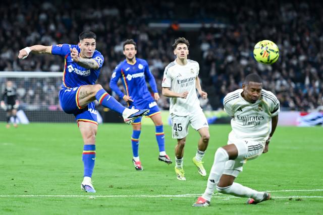 (260303) -- MADRID, March 3, 2026 (Xinhua) -- Getafe's Martin Satriano (L) socres during the La Liga football match between Real Madrid and Getafe CF in Madrid, Spain, on March 2, 2026. (Photo by Gustavo Valiente/Xinhua)