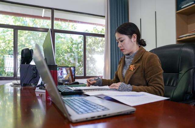 (260303) -- KUNMING, March 3, 2026 (Xinhua) -- Jin Ruirui files suggestions at her office in Mouding County, southwest China's Yunnan Province, Feb. 9, 2026.
  Jin Ruirui, president of the county-level Yi embroidery association, has been dedicated to preserving the millennia-old craft while leading local embroiderers toward cultural prosperity and rural revitalization.
  With a history of more than 1,300 years, Yi embroidery features exquisite patterns and diverse stitching techniques, serving as an important carrier of ethnic Yi culture. 
  Over the years, Jin has helped more than 2,000 women find jobs. Through their efforts, the ancient craft has stepped out of the mountains and appeared on fashion week runways in cities such as Milan, New York and Paris. By blending with modern fashion design, it has repeatedly expanded into new markets and reached new audience.
  In 2023, Jin was elected a deputy to the National People's Congress (NPC). During her tenure, she has put forward proposals on issues such as the protection of Yi embroidery and related industrial development, employment, education, and healthcare.
  At this year's "two sessions," Jin will focus on the industrial growth of Yi embroidery, youth mental health and the prevention of juvenile crime. (Xinhua/Chen Xinbo)