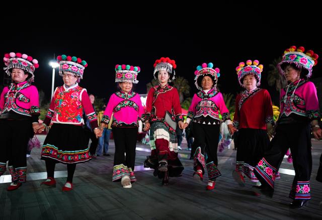(260303) -- KUNMING, March 3, 2026 (Xinhua) -- Jin Ruirui (C) dances with locals in Mouding County, southwest China's Yunnan Province, Feb. 9, 2026.
  Jin Ruirui, president of the county-level Yi embroidery association, has been dedicated to preserving the millennia-old craft while leading local embroiderers toward cultural prosperity and rural revitalization.
  With a history of more than 1,300 years, Yi embroidery features exquisite patterns and diverse stitching techniques, serving as an important carrier of ethnic Yi culture. 
  Over the years, Jin has helped more than 2,000 women find jobs. Through their efforts, the ancient craft has stepped out of the mountains and appeared on fashion week runways in cities such as Milan, New York and Paris. By blending with modern fashion design, it has repeatedly expanded into new markets and reached new audience.
  In 2023, Jin was elected a deputy to the National People's Congress (NPC). During her tenure, she has put forward proposals on issues such as the protection of Yi embroidery and related industrial development, employment, education, and healthcare.
  At this year's "two sessions," Jin will focus on the industrial growth of Yi embroidery, youth mental health and the prevention of juvenile crime. (Xinhua/Chen Xinbo)