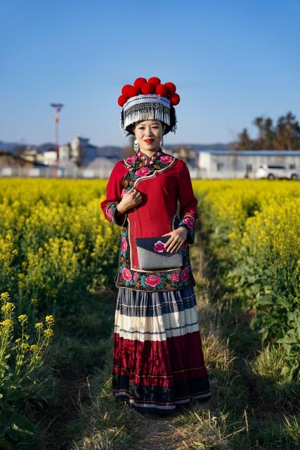 (260303) -- KUNMING, March 3, 2026 (Xinhua) -- Jin Ruirui poses for a photo in Mouding County, southwest China's Yunnan Province, Feb. 9, 2026.
  Jin Ruirui, president of the county-level Yi embroidery association, has been dedicated to preserving the millennia-old craft while leading local embroiderers toward cultural prosperity and rural revitalization.
  With a history of more than 1,300 years, Yi embroidery features exquisite patterns and diverse stitching techniques, serving as an important carrier of ethnic Yi culture. 
  Over the years, Jin has helped more than 2,000 women find jobs. Through their efforts, the ancient craft has stepped out of the mountains and appeared on fashion week runways in cities such as Milan, New York and Paris. By blending with modern fashion design, it has repeatedly expanded into new markets and reached new audience.
  In 2023, Jin was elected a deputy to the National People's Congress (NPC). During her tenure, she has put forward proposals on issues such as the protection of Yi embroidery and related industrial development, employment, education, and healthcare.
  At this year's "two sessions," Jin will focus on the industrial growth of Yi embroidery, youth mental health and the prevention of juvenile crime. (Xinhua/Chen Xinbo)