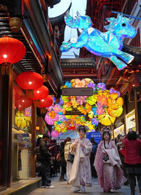 (260303) -- SHANGHAI, March 3, 2026 (Xinhua) -- Tourists view lanterns during the Lantern Festival celebrations at the Yuyuan Garden in Shanghai, east China, March 2, 2026. Various activities were held during this year's Lantern Festival celebrations at Yuyuan Garden of east China's Shanghai, drawing large numbers of tourists. (Xinhua/Liu Ying)