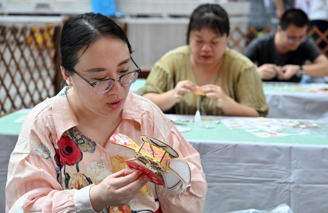 (260303) -- BEIJING, March 3, 2026 (Xinhua) -- People make lanterns in celebration of the Lantern Festival at Hainan Museum in Haikou, south China's Hainan Province, March 3, 2026. Across China, a variety of vibrant activities were held in celebration of the Lantern Festival, which falls on the fifteenth day of the first month of the Chinese lunar calendar, or March 3 this year. (Xinhua/Guo Cheng)