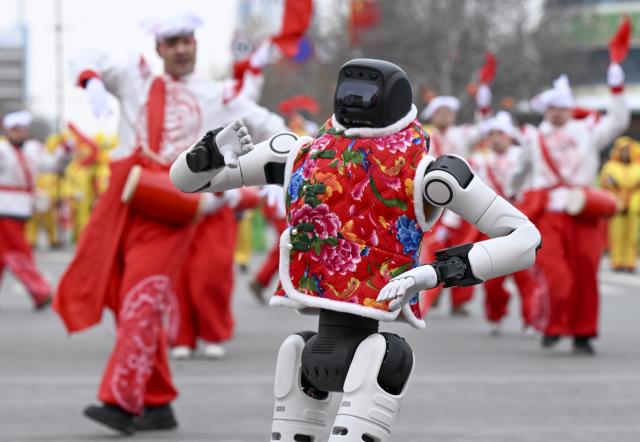 (260303) -- BEIJING, March 3, 2026 (Xinhua) -- A humanoid robot dances during a Shehuo gala in celebration of the Lantern Festival in Changji City, northwest China's Xinjiang Uygur Autonomous Region, March 3, 2026. Across China, a variety of vibrant activities were held in celebration of the Lantern Festival, which falls on the fifteenth day of the first month of the Chinese lunar calendar, or March 3 this year. (Xinhua/Wang Fei)