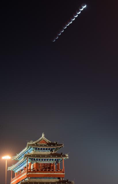 (260303) -- BEIJING, March 3, 2026 (Xinhua) -- This stack composite photo taken on March 3, 2026 shows the moon during a total lunar eclipse over Yongdingmen Gate in Beijing, capital of China. Tuesday marked the Lantern Festival, which falls on the 15th day of the first month of the Chinese lunar calendar. This year's festival coincided with a total lunar eclipse. (Xinhua/Hu Jingwen)