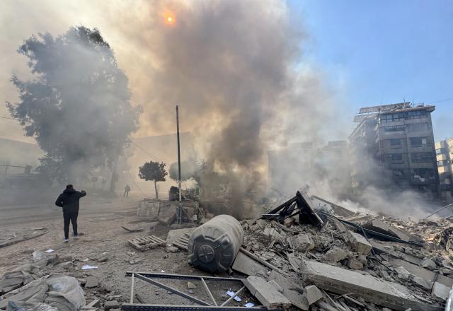 (260303) -- BEIRUT, March 3, 2026 (Xinhua) -- People walk past the rubble after Israel's overnight bombing of Beirut's southern suburbs, March 3, 2026. Two members of the Islamic Health Authority were killed on Tuesday in an Israeli airstrike on the southern Lebanese town of Siddiqine, the state-run National News Agency (NNA) reported.
   The escalation extended beyond the border region to Beirut's southern suburbs, where Israeli warplanes carried out a new series of intense airstrikes without prior warning, causing significant damage to targeted buildings, NNA said. (Photo by Bilal Jawich/Xinhua)