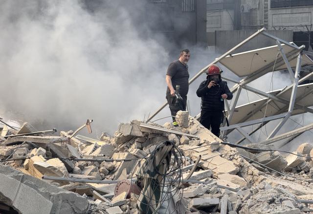 (260303) -- BEIRUT, March 3, 2026 (Xinhua) -- Rescue workers search through the rubble after Israel's overnight bombing of Beirut's southern suburbs, March 3, 2026. Two members of the Islamic Health Authority were killed on Tuesday in an Israeli airstrike on the southern Lebanese town of Siddiqine, the state-run National News Agency (NNA) reported.
   The escalation extended beyond the border region to Beirut's southern suburbs, where Israeli warplanes carried out a new series of intense airstrikes without prior warning, causing significant damage to targeted buildings, NNA said. (Photo by Bilal Jawich/Xinhua)