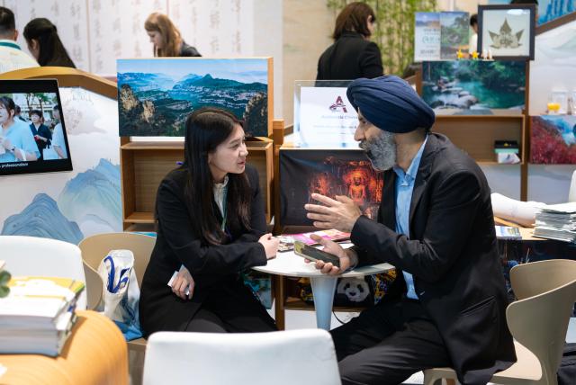 (260303) -- BERLIN, March 3, 2026 (Xinhua) -- People communicate at the China Pavilion at the ITB Berlin travel trade show in Berlin, Germany on March 3, 2026. This year's ITB Berlin travel trade show kicked off here on Tuesday and will last until March 5. First held in 1966, the event celebrates its 60th anniversary this year. (Xinhua/Zhang Haofu)
