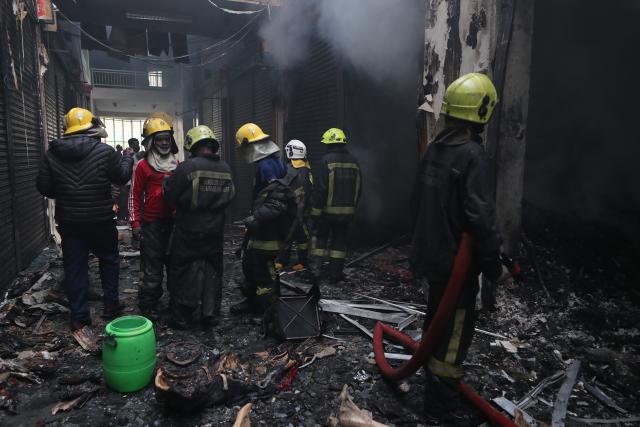 (260303) -- NAIROBI, March 3, 2026 (Xinhua) -- Firefighters gather at the scene of a fire at Yare Plaza in Nairobi, capital of Kenya, on March 3, 2026. A fire broke out on Tuesday at Yare Plaza, a place which mainly houses clothing vendors. (Photo by Henry Naminde/Xinhua)