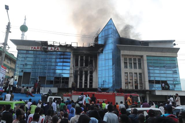 (260303) -- NAIROBI, March 3, 2026 (Xinhua) -- People gathered outside Yare Plaza where a fire broke out in Nairobi, capital of Kenya, on March 3, 2026. A fire broke out on Tuesday at Yare Plaza, a place which mainly houses clothing vendors. (Photo by Henry Naminde/Xinhua)