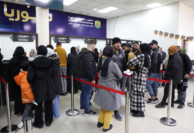 (260303) -- JDEIDET YABOUS, March 3, 2026 (Xinhua) -- People wait to have their travel documents checked at the Jdeidet Yabous border crossing with Lebanon in Rural Damascus, Syria, March 3, 2026. As Israeli airstrikes hammered Lebanon, thousands of Syrians began their journey home, turning the border into a tense and crowded corridor of hurried goodbyes and uncertain reunions. (Photo by Ammar Safarjalani/Xinhua)