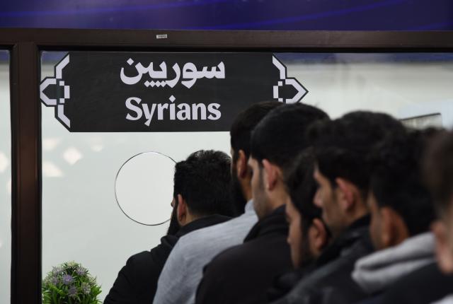 (260303) -- JDEIDET YABOUS, March 3, 2026 (Xinhua) -- People queue to have their travel documents checked at the Jdeidet Yabous border crossing with Lebanon in Rural Damascus, Syria, March 3, 2026. As Israeli airstrikes hammered Lebanon, thousands of Syrians began their journey home, turning the border into a tense and crowded corridor of hurried goodbyes and uncertain reunions. (Photo by Monsef Memari/Xinhua)