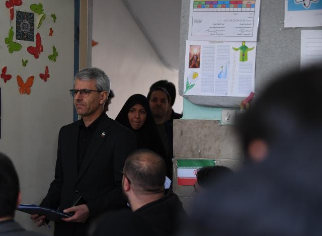 (260303) -- TEHRAN, March 3, 2026 (Xinhua) -- Iranian Foreign Ministry spokesman Esmaeil Baghaei walks into a room ahead of a weekly press conference held in a war-damaged school in Tehran, Iran, on March 3, 2026. Baghaei on Tuesday warned about bids by Israel to expand the scope of the war with Iran to the entire West Asia region. (Xinhua/Shadati)