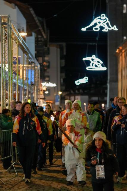 (260304) -- CORTINA D'AMPEZZO, March 4, 2026 (Xinhua) -- A torchbearer carrys the torch during the Milan-Cortina 2026 Paralympic Winter Games Torch Relay and Flame Unifying Ceremony in Cortina D'Ampezzo, Italy, March 3, 2026. (Xinhua/Lian Zhen)