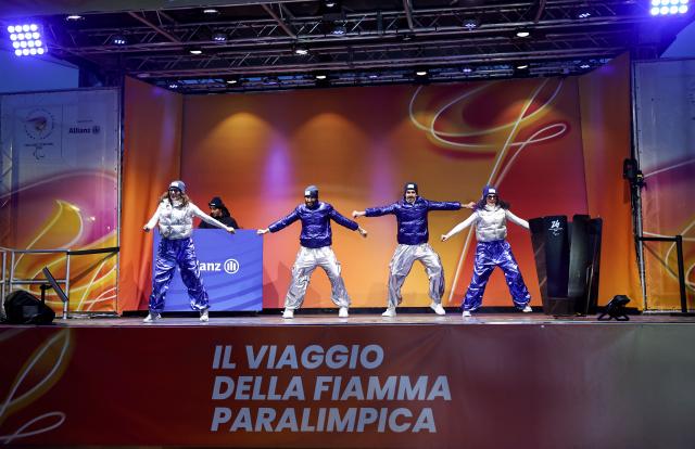 (260304) -- CORTINA D'AMPEZZO, March 4, 2026 (Xinhua) -- Dancers perform during the Milan-Cortina 2026 Paralympic Winter Games Torch Relay and Flame Unifying Ceremony in Cortina D'Ampezzo, Italy, March 3, 2026. (Xinhua/Wang Kaiyan)