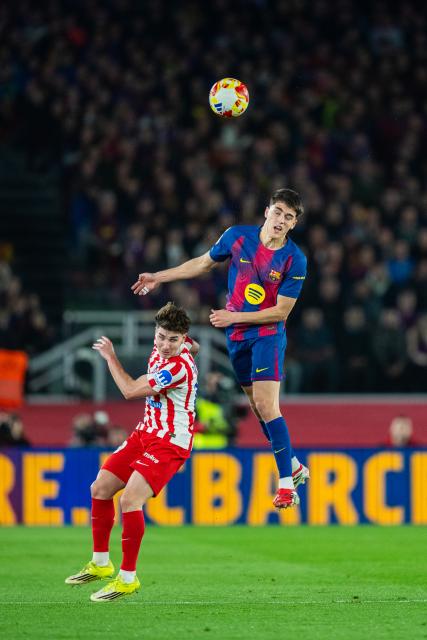 (260304) -- BARCELONA, March 4, 2026 (Xinhua) -- Pau Cubarsi of FC Barcelona (R) vies for a header with Julian Alvarez of Atletico de Madrid during the Copa del Rey semifinal round 2 match between FC Barcelona and  Atletico de Madrid in Barcelona, Spain, March 3, 2026. (Photo by Joan Gosa/Xinhua)