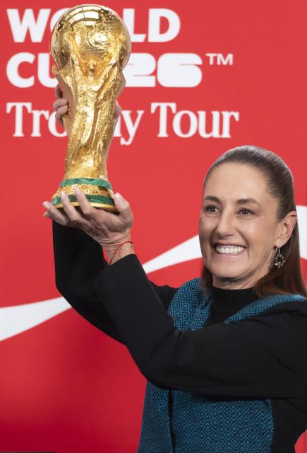 (260304) -- MEXICO CITY, March 4, 2026 (Xinhua) -- Mexican President Claudia Sheinbaum lifts the FIFA World Cup trophy during a FIFA World Cup Trophy Tour at a press conference in Mexico City, Mexico, March 3, 2026. (Mexico's Presidency/Handout via Xinhua)