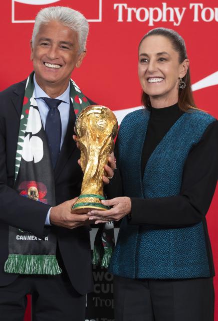 (260304) -- MEXICO CITY, March 4, 2026 (Xinhua) -- Mexican President Claudia Sheinbaum (R) and former Brazilian football player and world champion Bebeto pose with the FIFA World Cup trophy during a FIFA World Cup Trophy Tour at a press conference in Mexico City, Mexico, March 3, 2026. (Mexico's Presidency/Handout via Xinhua)