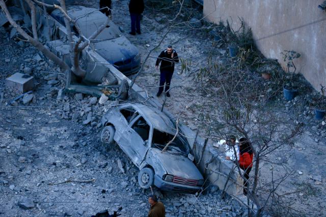 (260304) -- SIDON, March 4, 2026 (Xinhua) -- People check damaged vehicles at the site of the Islamic Group's offices destroyed by Israeli airstrikes in Sidon, southern Lebanon, March 3, 2026. (Photo by Ali Hashisho/Xinhua)