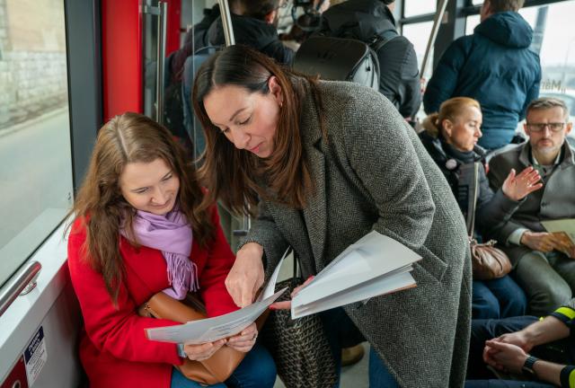 (260304) -- PRAGUE, March 4, 2026 (Xinhua) -- A psychosocial support worker (R, front) shares information with a passenger on a specially designed "Mental Health Tram" in Prague, the Czech Republic, on March 3, 2026.
  Prague has unveiled a specially designed "Mental Health Tram" as part of its "Help Is Within Reach" campaign to destigmatize mental health issues and encourage residents to seek support.
  The tram will operate on regular routes for approximately seven weeks to raise public awareness of accessible mental health resources. (Photo by Dana Kesnerova/Xinhua)