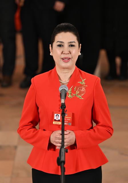 (260304) -- BEIJING, March 4, 2026 (Xinhua) -- Muyassar Tohti, a member of the 14th National Committee of the Chinese People's Political Consultative Conference (CPPCC), attends a group interview ahead of the opening meeting of the fourth session of the 14th CPPCC National Committee at the Great Hall of the People in Beijing, capital of China, March 4, 2026. (Xinhua/Cao Yiming)