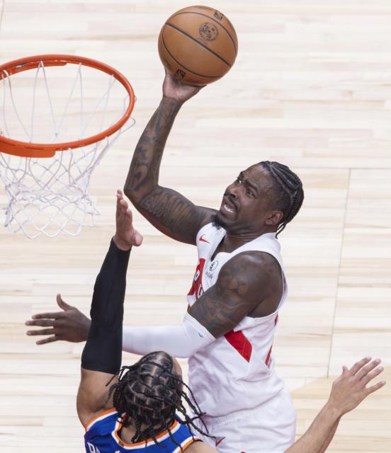 (260304) -- TORONTO, March 4, 2026 (Xinhua) -- Jamal Shead (top) of Toronto Raptors goes up for a layup during the 2025-2026 NBA regular season game between Toronto Raptors and New York Knicks in Toronto, Canada, on March 3, 2026. (Photo by Zou Zheng/Xinhua)