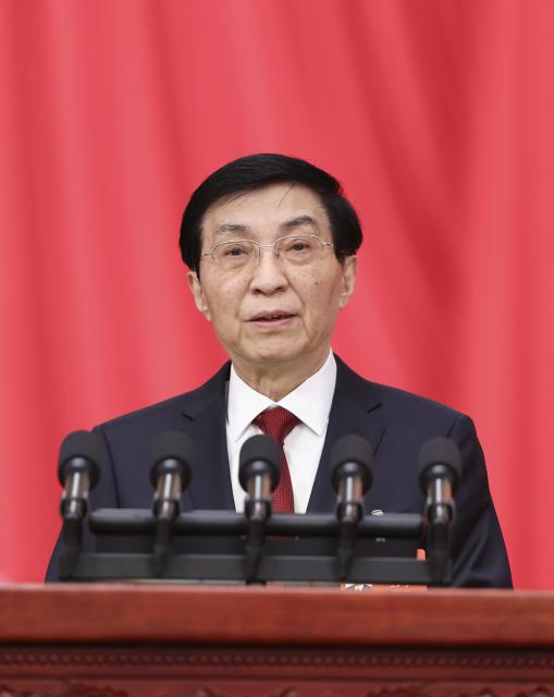 (260304) -- BEIJING, March 4, 2026 (Xinhua) -- Wang Huning, chairman of the Chinese People's Political Consultative Conference (CPPCC) National Committee, delivers a work report on behalf of the Standing Committee of the CPPCC National Committee at the opening meeting of the fourth session of the 14th CPPCC National Committee at the Great Hall of the People in Beijing, capital of China, March 4, 2026. (Xinhua/Yao Dawei)
