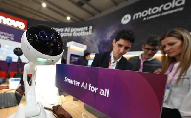 (260304) -- BARCELONA, March 4, 2026 (Xinhua) -- Staff members work at the Lenovo booth during the 2026 Mobile World Congress (MWC) in Barcelona, Spain, March 3, 2026.
  The 2026 Mobile World Congress (MWC) opened on Monday in Barcelona, Spain. According to its organizers, a China Pavilion has been set up at the congress for the first time, featuring major Chinese companies including China Mobile, China Unicom, Huawei, ZTE, Honor and Xiaomi, showcasing their latest advancements in mobile communications and AI technologies. (Xinhua/Cheng Min)