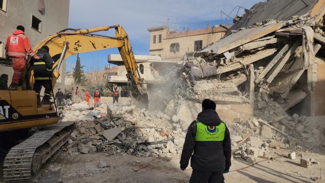 (260304) -- BAALBEK, March 4, 2026 (Xinhua) -- Rescuers search on ruins of a residential complex attacked by an Israeli airstrike in Baalbek, Lebanon, March 4, 2026. In eastern Lebanon, five people were killed and 15 others injured in an Israeli airstrike on a residential complex in the city of Baalbek, the state-run National News Agency reported. (Photo by Taher Abu Hamdan/Xinhua)