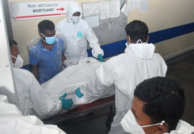 (260304) -- COLOMBO, March 4, 2026 (Xinhua) -- People transport the bodies of Iranian soldiers killed in an American torpedo attack on their ship IRIS Dena off the southern coast of Sri Lanka to the morgue of a hospital in Galle, Sri Lanka, on March 4, 2026. At least 80 people on board the Iranian frigate IRIS Dena were killed after the vessel was attacked and sunk by the U.S. submarine in the Indian Ocean off the southern coast of Sri Lanka, Sri Lanka's Deputy Minister of Foreign Affairs Arun Hemachandra said Wednesday. (Photo by Ajith Perera/Xinhua)