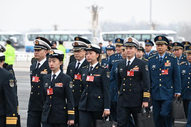 (260305) -- BEIJING, March 5, 2026 (Xinhua) -- Deputies to the 14th National People's Congress (NPC) walk towards the Great Hall of the People for the opening meeting of the fourth session of the 14th NPC in Beijing, capital of China, March 5, 2026. (Xinhua/Cao Yiming)