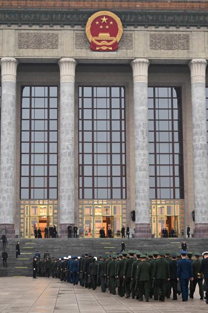 (260305) -- BEIJING, March 5, 2026 (Xinhua) -- Deputies to the 14th National People's Congress (NPC) walk towards the Great Hall of the People for the opening meeting of the fourth session of the 14th NPC in Beijing, capital of China, March 5, 2026. (Xinhua/Cheng Tingting)