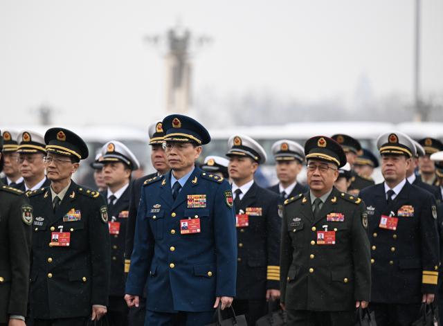 (260305) -- BEIJING, March 5, 2026 (Xinhua) -- Deputies to the 14th National People's Congress (NPC) walk towards the Great Hall of the People for the opening meeting of the fourth session of the 14th NPC in Beijing, capital of China, March 5, 2026. (Xinhua/Cheng Tingting)