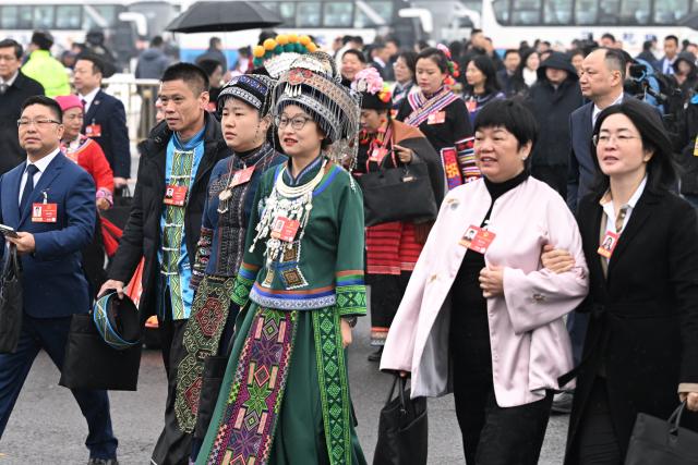 (260305) -- BEIJING, March 5, 2026 (Xinhua) -- Deputies to the 14th National People's Congress (NPC) walk towards the Great Hall of the People for the opening meeting of the fourth session of the 14th NPC in Beijing, capital of China, March 5, 2026. (Xinhua/Li He)