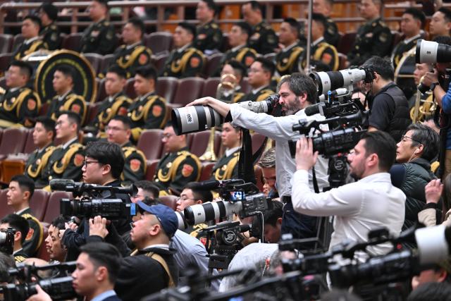 (260305) -- BEIJING, March 5, 2026 (Xinhua) -- Journalists work at the opening meeting of the fourth session of the 14th National People's Congress (NPC) at the Great Hall of the People in Beijing, capital of China, March 5, 2026. (Xinhua/Li Xin)