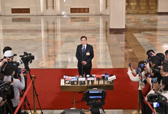 (260305) -- BEIJING, March 5, 2026 (Xinhua) -- Zhang Yuzhuo, head of the State-owned Assets Supervision and Administration Commission of the State Council, gives an interview after the opening meeting of the fourth session of the 14th National People's Congress (NPC) at the Great Hall of the People in Beijing, capital of China, March 5, 2026. (Xinhua/Li Xin)