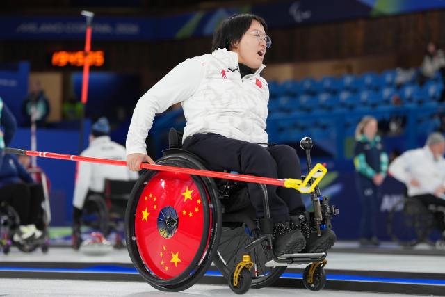 (260305) -- CORTINA D'AMPEZZO, March 5, 2026 (Xinhua) -- Wang Meng of China reacts during the wheelchair curling mixed doubles round robin session 1 match between China and Japan at the Milan-Cortina 2026 Paralympic Winter Games in Cortina D'ampezzo, Italy, March 4, 2026. (Xinhua/Lian Yi)