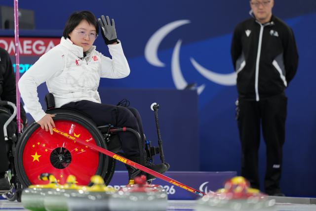 (260305) -- CORTINA D'AMPEZZO, March 5, 2026 (Xinhua) -- Wang Meng of China reacts during the wheelchair curling mixed doubles round robin session 1 match between China and Japan at the Milan-Cortina 2026 Paralympic Winter Games in Cortina D'ampezzo, Italy, March 4, 2026. (Xinhua/Lian Yi)