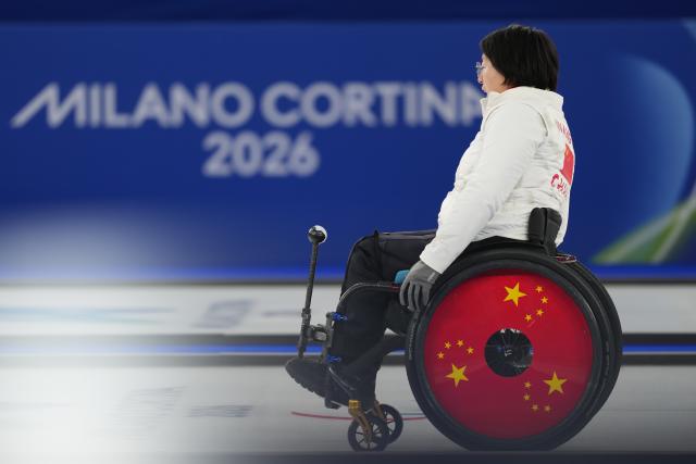 (260305) -- CORTINA D'AMPEZZO, March 5, 2026 (Xinhua) -- Wang Meng of China reacts during the wheelchair curling mixed doubles round robin session 1 match between China and Japan at the Milan-Cortina 2026 Paralympic Winter Games in Cortina D'ampezzo, Italy, March 4, 2026. (Xinhua/Lian Yi)
