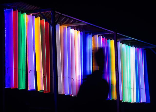(260305) -- TORONTO, March 5, 2026 (Xinhua) -- A visitor walks past a light art installation during the "Lumiere: The Art of Light" exhibition in Toronto, Canada, on March 4, 2026. The annual outdoor light exhibition is held here from Feb. 16 to March 27. (Photo by Zou Zheng/Xinhua)