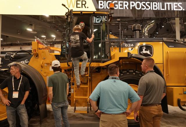 (260305) -- LAS VEGAS, March 5, 2026 (Xinhua) -- People visit the John Deere booth at the 2026 CONEXPO-CON/AGG in Las Vegas, the United States, on March 4, 2026. Global construction equipment manufacturers are gathering in Las Vegas from Tuesday to Saturday for the 2026 CONEXPO-CON/AGG, showcasing a broad shift toward artificial intelligence (AI) and autonomous operations. (Photo by Zeng Hui/Xinhua)