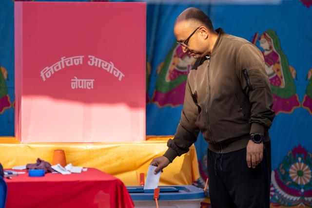 (260305) -- LALITPUR, March 5, 2026 (Xinhua) -- A man casts his ballot at a polling station during the parliamentary election in Lalitpur, Nepal, on March 5, 2026. Voting began across Nepal on Thursday morning to elect a new House of Representatives that was dissolved following violent protests in September last year. (Photo by Hari Maharjan/Xinhua)