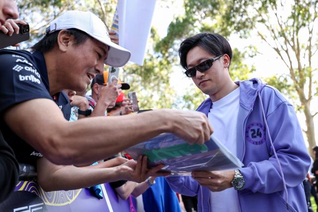 (260305) -- MELBOURNE, March 5, 2026 (Xinhua) -- Cadillac's Zhou Guanyu (R) (Reserve Driver) of China signs autographs to the fans during the Media Day of the Formula One Australia Grand Prix in Melbourne, Australia, March 5, 2026. (Photo by Qian Jun/Xinhua)