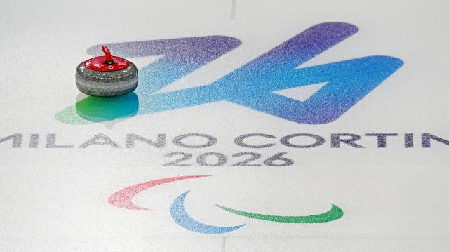 (260305) -- CORTINA D'AMPEZZO, March 5, 2026 (Xinhua) -- A curling stone thrown by Wang Meng of China is seen during the wheelchair curling mixed doubles round robin session 2 match between China and Latvia at the Milan-Cortina 2026 Paralympic Winter Games in Cortina D'ampezzo, Italy, March 5, 2026. (Xinhua/Cai Yang)